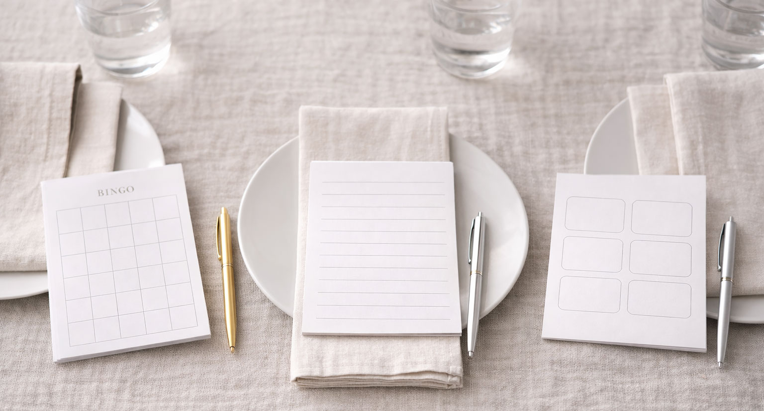 Organized baby shower table setup with printable games and pens ready