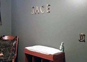 The letters that spell baby's name on the nursery wall are made with deer horns