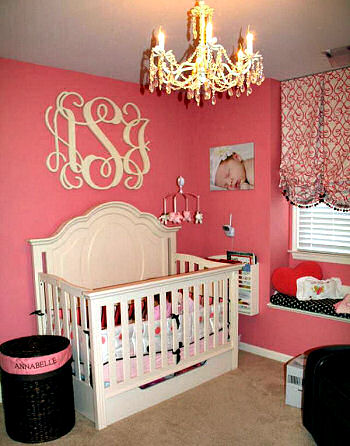 Elegant pink black and ivory baby girl nursery room fit for a princess with large circular shape wooden wall letters monogram