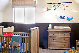 Colorful airplane nursery theme decorated for a baby boy with a mix of modern and vintage planes