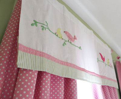 Pink and white curtain panels with polka dots and a window valance topper with bird appliques