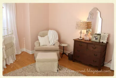 Antique white and pink baby girl nursery with vintage dresser