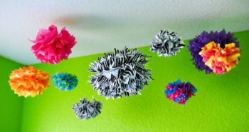 Colorful tissue paper pom poms nursery ceiling decorations in zebra print and other bright colors