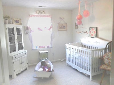 Our baby girl, Magnolia's shabby chic nursery in pink with a vintage sailboat that she loves to play with.