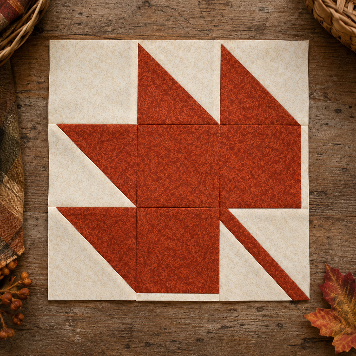 Twelve inch pieced maple leaf quilt block showing ivory background half square triangles solid leaf squares and diagonal stem unit