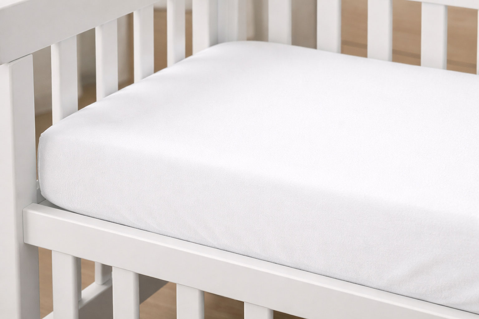 mini crib mattress fitting snugly inside crib frame with no visible gaps