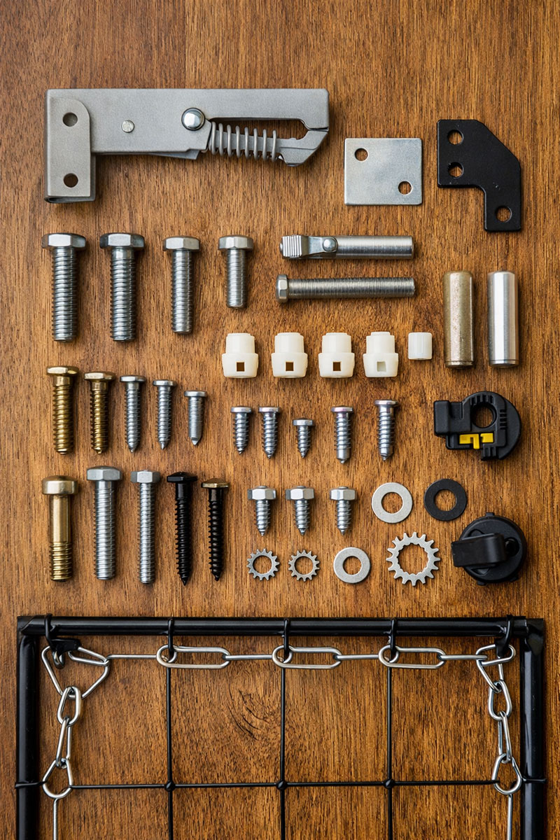 Missing crib replacement parts including screws, bolts, and mattress support hardware laid out for identification reference