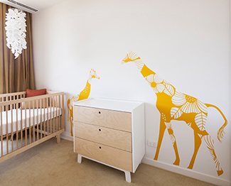 Large mother and baby giraffe nursery wall decals in a modern baby room