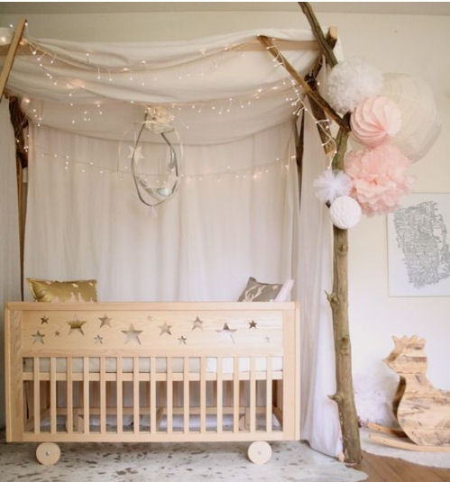 Celestial moon and stars baby nursery decorating ideas wooden handmade star themed baby crib and sparkling lights.