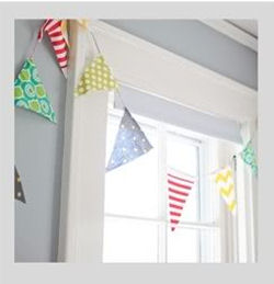 Fabric baby pennant flags banner with chevron stripes and polka dots in a shared nursery