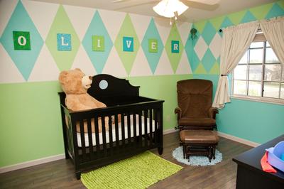 Argyle accent wall in a baby boy sports theme nursery painted with mint green and aqua blue paint