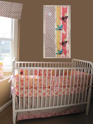 Our baby girl's colorful custom nursery was designed with bedding and nursery decor from the 