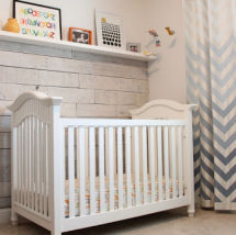 Neutral gray and white nursery with chevron curtains and recycled wood pallet wall decor