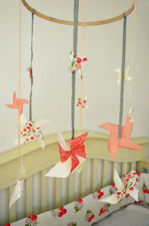 Homemade pinwheel baby crib mobile made with ribbon left over from an Anthropologie bag and scrapbook paper for a baby girl peach cherry nursery room