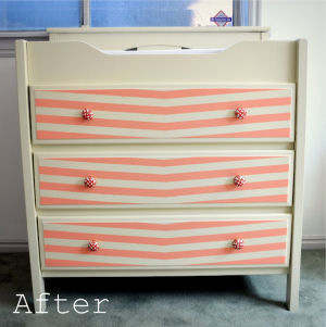 Peach and ivory baby girl nursery changing table dresser combination with Anthropologie knobs drawer pulls