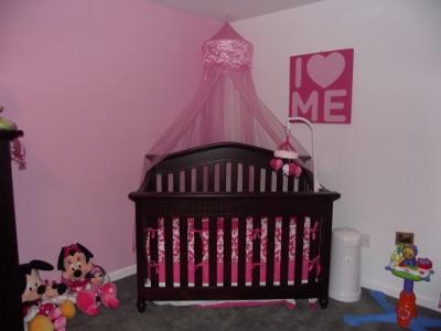 A baby girl nursery room with gray wall paint apple custom crib bedding set with red accent colors