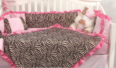 Pink and brown zebra print baby bedding set for a crib in a feminine baby girl nursery room