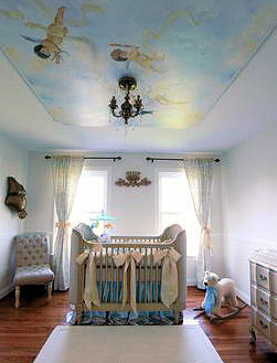 Baby blue boy nursery design with a cherub ceiling mural