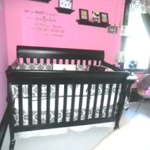 A black and white damask baby girl nursery crib bedding set is pretty with a pink wall paint color