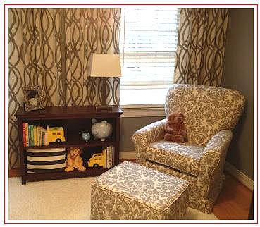 Baby nursery chair upholstered in gray and creamy antique white damask upholstery fabric