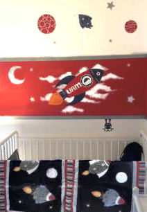 Moon stars planets and rocket ship vinyl wall art with the baby boy's name included in the decals