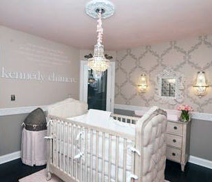 Elegant baby crib with tufted upholstery in a baby girl nursery room