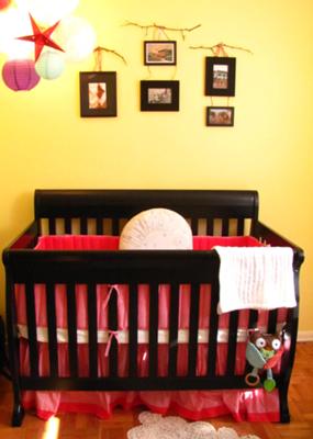 Gender neutral Rustic Chic and Cheeky Nursery Decor.  The tree branches give the wall arrangement of photos a distinctly rustic but sophisticated appearance.