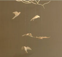 Wooden baby nursery mobile suspended from wood branches and twigs