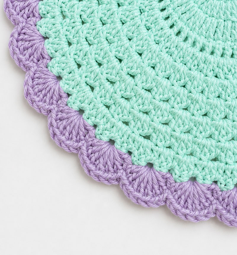 Scalloped lavender crochet edge on a seafoam seahorse lovey blanket