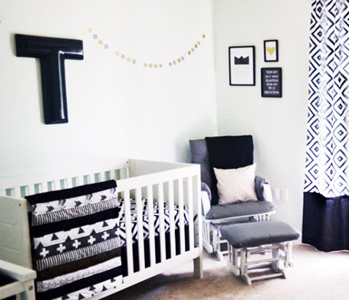 Modern black and white neutral baby nursery decorating ideas with crosses triangles geometric patterns