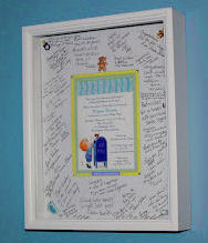 Framed baby boy shower invitation with autographs and wishes from the guests