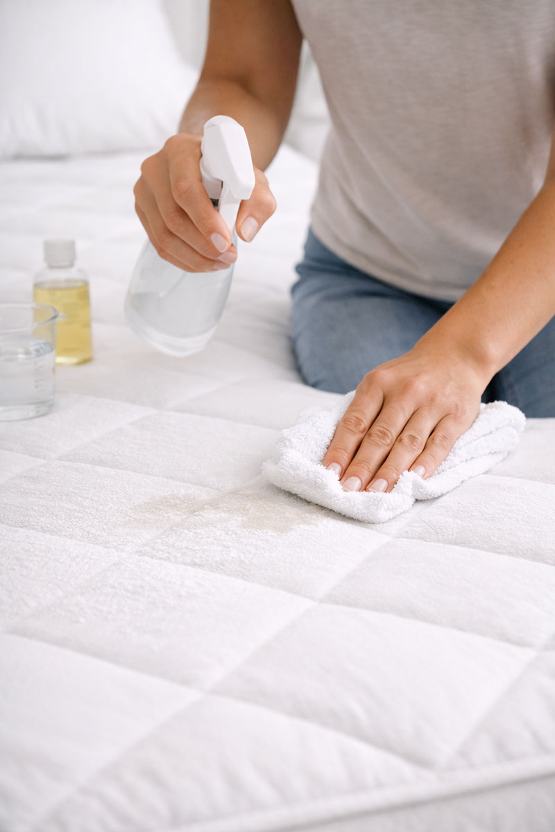 Spot cleaning a mattress with cloth and mild solution