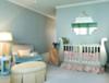 Elegant blush pink and blue baby nursery with metallic silver crib.