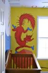 The Fox in Socks portion of the Dr. Seuss nursery wall mural near the baby's crib.