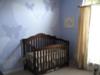 A view of our baby girl's crib, the hand-painted butterflies nursery wall mural in shades of lavender and window treatments. 