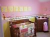 The yellow wall letters spell out Sophie's name.  The pink wall paint color of her Winnie the Pooh theme nursery is the perfect background for them.