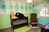 Baby Oliver's blue and green argyle nursery has a splash of a sports theme