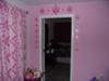 Removable, vinyl Amy Coe wall decals in pink replicate the fabric pattern of the curtain panels and crib set. 