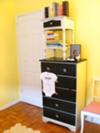 I painted the vintage nursery dresser in black and white and then updated the drawer pulls.  It looks amazing with the baby's yellow nursery walls.