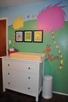 The baby's nursery wall is painted with a colorful Lorax tree mural  based on the Dr Seuss book.