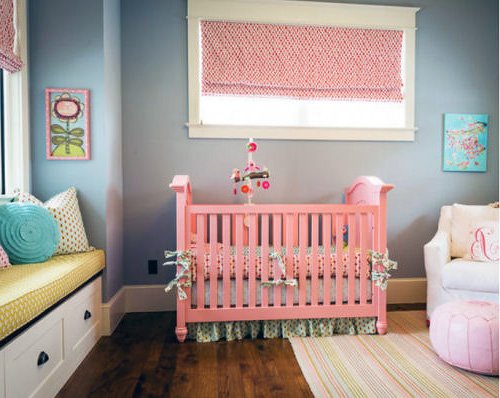 Transitional baby nursery with a crib painted pink.