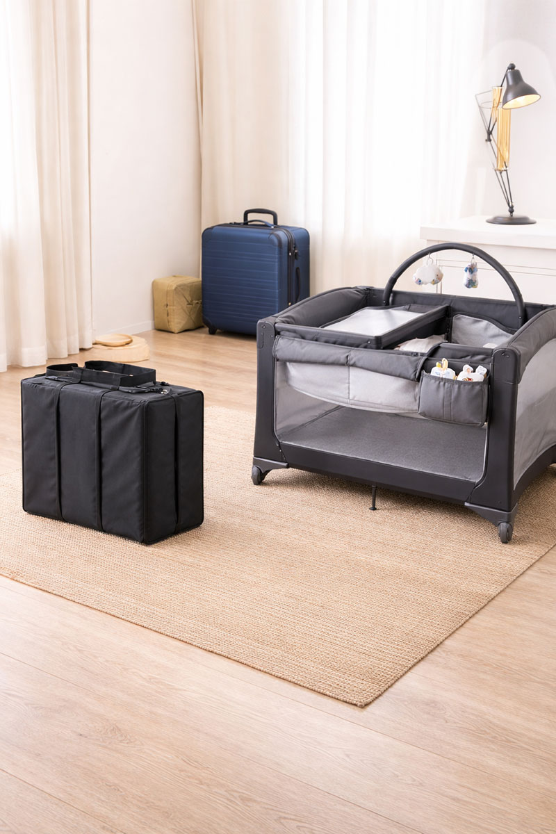 Travel crib folded next to pack and play showing portable baby sleep size comparison