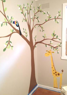 A Tree Wall Mural in a baby girl nursery room with toucan bird and a giraffe
