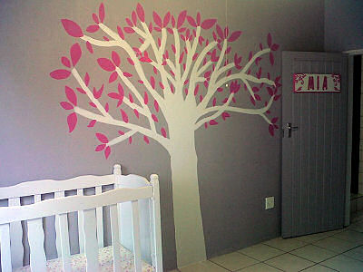 Homemade diy painted tree on the wall of a baby girl nursery room