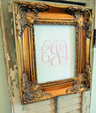 Elegant pink monogram with a baby girl's initials in a vintage picture frame