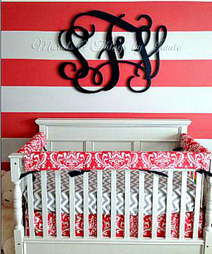 Watermelon pink nursery wall paint color used in a striped wall painting technique