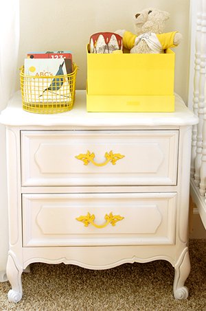 Vintage DIY night stand makeover before and after pictures painted white with yellow drawer pulls for a baby nursery