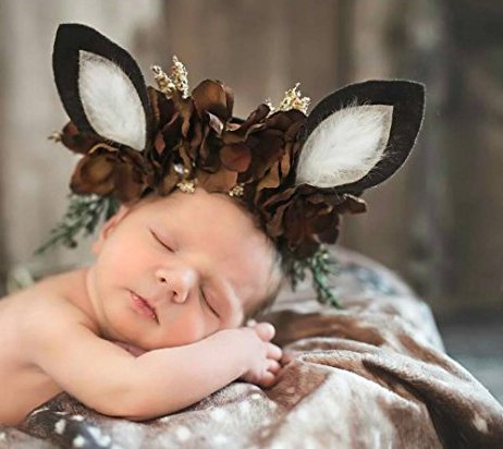 Newborn baby photo posing idea.  Infant pose with deer ears wrapped in baby fawn print blanket photo prop.