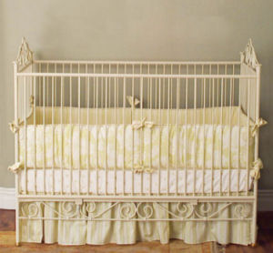 Yellow toile baby nursery bedding set in an antique off white crib