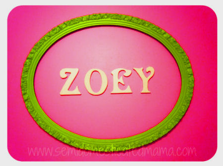 Bright lime green painted oval framed wooden wall letters look cool with the hot pink paint color of this baby girl nursery